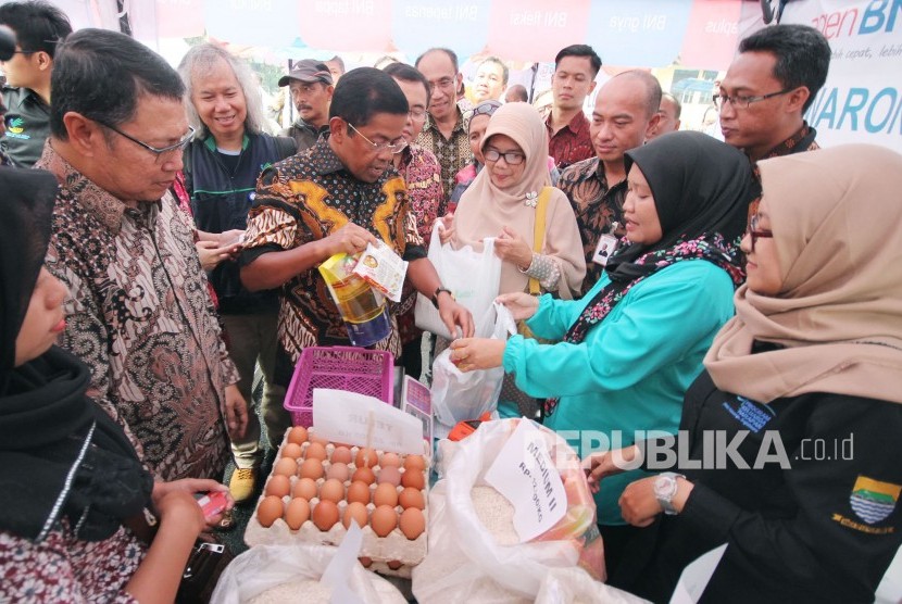 Menteri Sosial RI Idrus Marham berbincang dengan warga penerima bantuan yang sedang berbelanja sembako usai penyerahan bantuan Penyaluran Bantuan Sosial Program Keluarga harapan (PKH) dan Bantuan Pangan Non Tunai (BPNT), di Aula Wyata Guna, Kota Bandung, Kamis (1/3).