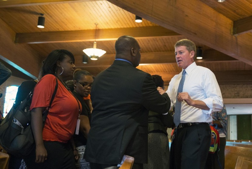 Missouri State Attorney General Chris Koster (R) greets parishioners after speaking about the need for law enforcement and the communities they police to work together better during church services at the Greater St Mark Family Church as the community disc