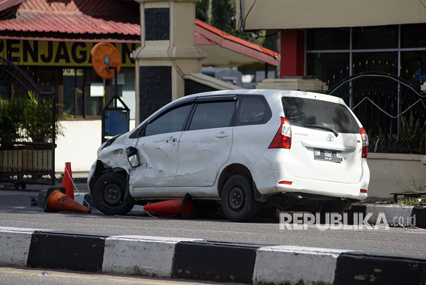 Mobil minibus yang digunakan pelaku teror dalam kondisi rusak di depan pintu masuk Polda Riau, di Pekanbaru, Riau, Rabu (16/5).