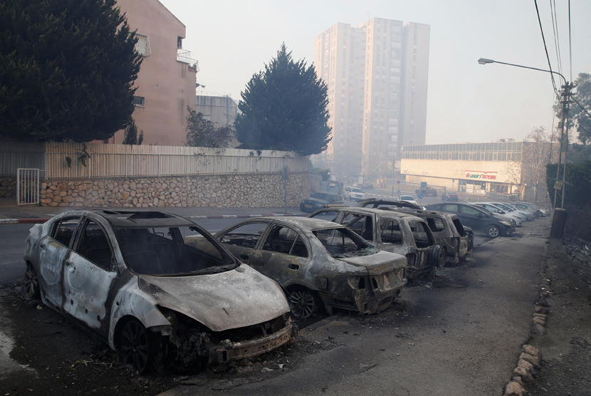 Mobil yang terbakar akibat kebakaran lahan di utara kota Haifa, Israel 24 November 2016. 