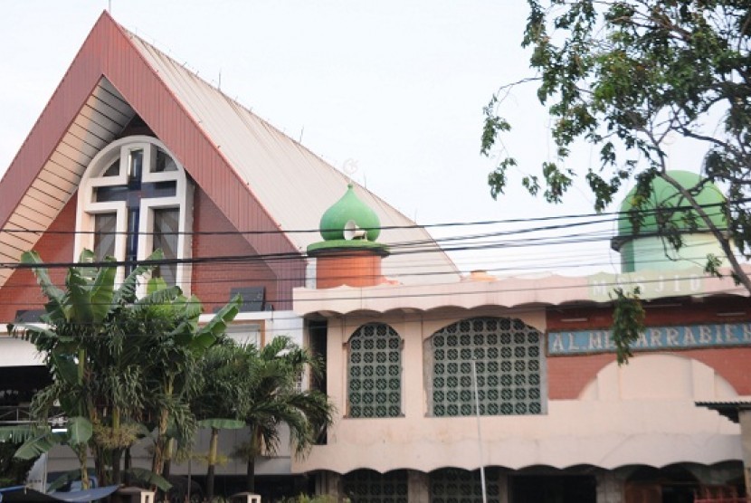 Mosque Al Muqarrabien (right) is built side by side with a Church Masehi Injili Sangihe Talaud in Tanjung Priuk,North Jakarta.    