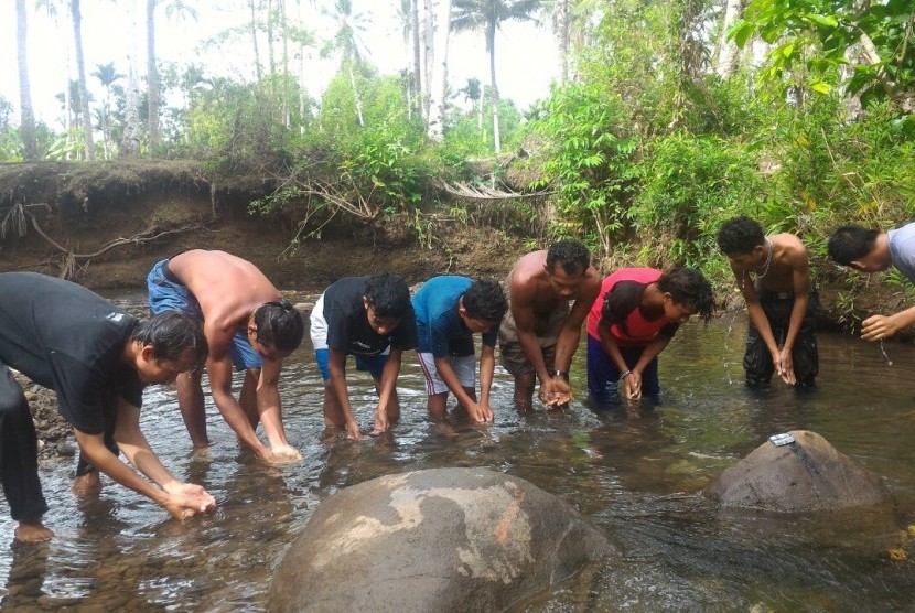 Mualaf Suku Togutil di Hutan Halmahera, Maluku Utara, belajar berwudhu di sungai.