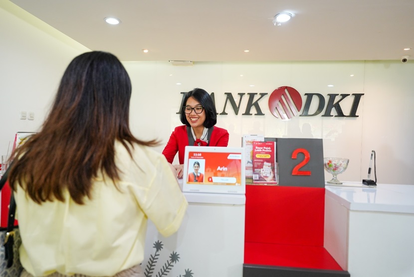 Pegawai Bank DKI melayana nasabah di kantor Bank DKI, Jakarta.