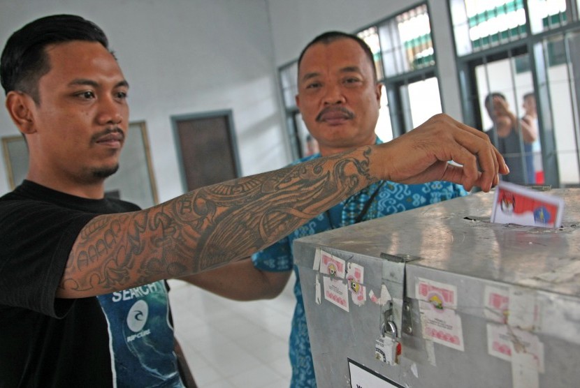 Napi memasukkan surat suara usai melakukan pencoblosan di Lapas Klas IIA Kendari, Sulawesi Tenggara, Rabu (15/2).