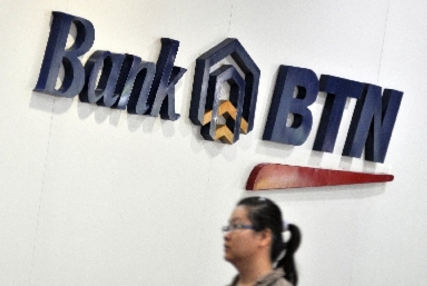 A customer walks in front of logo BTN Bank in Jakarta. (File photo)