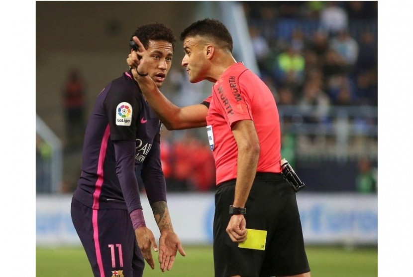 Neymar (kiri) saat diberi kartu kuning oleh wasit Gil Manzano.