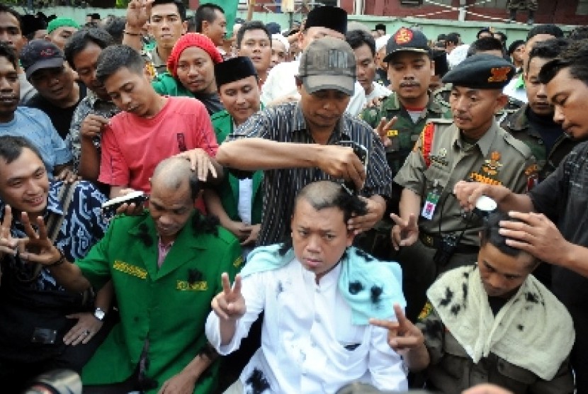 Nusron Wahid (tengah) bersama para simpatisan organisasi melakukan aksi penggundulan rambut massal di markas mereka di Jalan Kramat, Jakarta, Selasa (22/7). 