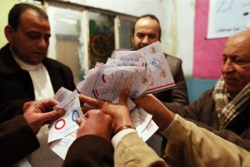 Officials count ballots after polls closed in Cairo, January 15, 2014.