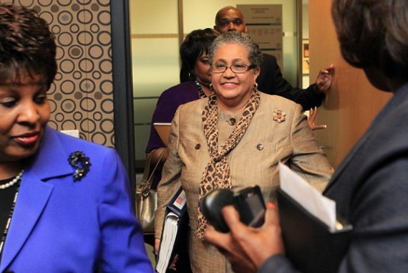 Outgoing schools superintendent, Dr. Beverly Hall (center), arrives for her last Atlanta school board meeting at the Atlanta Public Schools headquarters in Atlanta. Hall and nearly three dozen other administrators, teachers, principals and other educators 