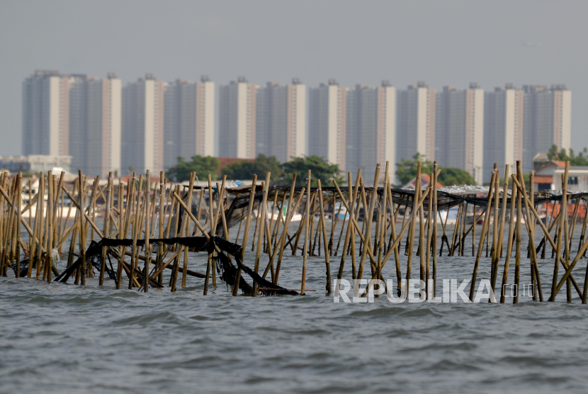 Pagar laut dengan latar belakang gedung apartemen PIK 2 terlihat di perairan Pantai Tanjung Pasir, Kabupaten Tangerang, Banten, Jumat (10/1/2024). Pagar laut juga ditemukan di Perairan Bekasi.