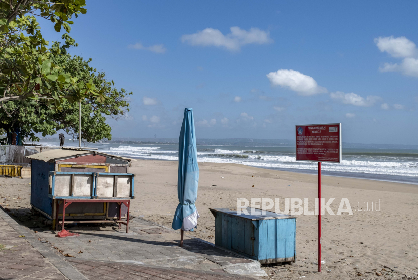 Pantai yang hampir kosong akibat pembatasan virus corona di kawasan wisata Kuta di Bali, Jumat (13/8/2021). Pemerintah Indonesia memperpanjang masa berlaku status darurat pembatasan mobilitas publik hingga 16 Agustus 2021.