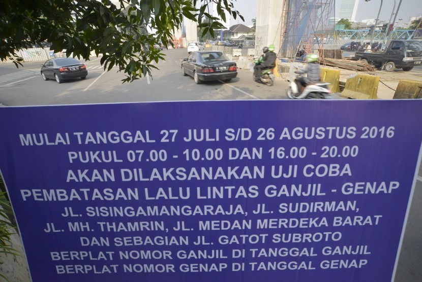 Papan informasi uji coba penerapan sistem lalu lintas pelat ganjil-genap terpampang di kawasan Blok M - Senayan, Jakarta, Selasa (26/7). 