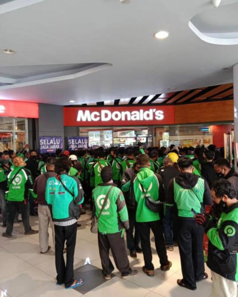 Para driver layanan pesanan makanan daring saat mengantre menu BTS Meal di gerai McD.