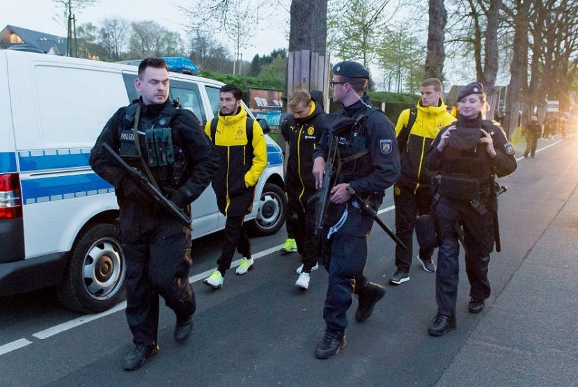 Para pemain Borussia Dortmund mendapatkan pengawalan dari kepolisian Jerman setelah ledakan bom merusak bus yang mereka tumpangi menjelang laga Liga Champions.