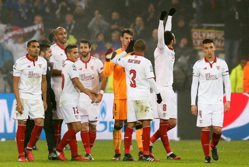 Para pemain Sevilla merayakan keberhasilan lolos ke babak 16besar Liga Champions seusai menahan imbang Olympique Lyon 0-0, Kamis (8/12).