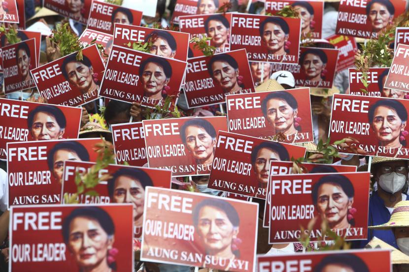 Para pengunjuk rasa memegang plakat dengan gambar pemimpin yang digulingkan Aung San Suu Kyi selama protes anti-kudeta di Mandalay, Myanmar, Minggu, 21 Februari 2021. Polisi di Myanmar menembak mati beberapa pengunjuk rasa anti-kudeta dan melukai beberapa lainnya pada hari Sabtu, ketika pasukan keamanan meningkatkan tekanan pada pemberontakan rakyat melawan pengambilalihan militer.