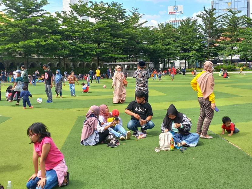 Para pengunjung yang tengah bermain di Taman Alun-Alun Bandung masih banyak yang abai prokes termasuk pengunjung yang sedang antre bis Bandros tidak menjaga jarak, Ahad (21/11). 