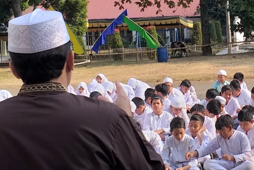 Para siswa SD Bosowa Bina Insani mendengarkan tausiyah sebelum menyaksikan pemotongan hewan kurban.