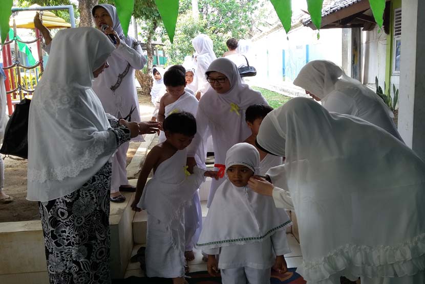 Para siswa TK Bina Insani melaksanakan tahalul (memotong sebagian rambut) pada peragaan manasik haji yang digelar di TK Bina Insani Bogor, Jawa Barat, Jumat (16/10).