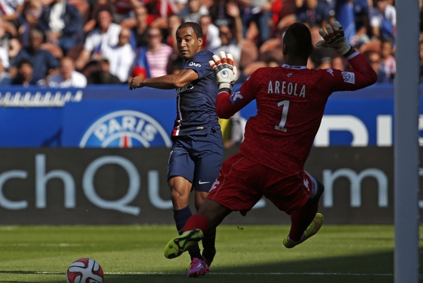 Paris St Germain's Lucas scores a goal against Bastia's Alphonse Areola (1) during their French Ligue 1 soccer match at the Parc des Princes Stadium in Paris, August 16, 2014. 