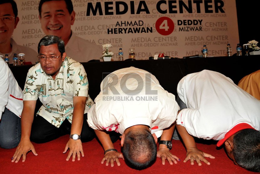   Pasangan Ahmad Heryawan-Deddy Mizwar berserta tim sukses melakukan sujud syukur di Media Center Aher-Deddy, Bandung, Jawa Barat, Ahad (24/2).  (Republika/Prayogi)