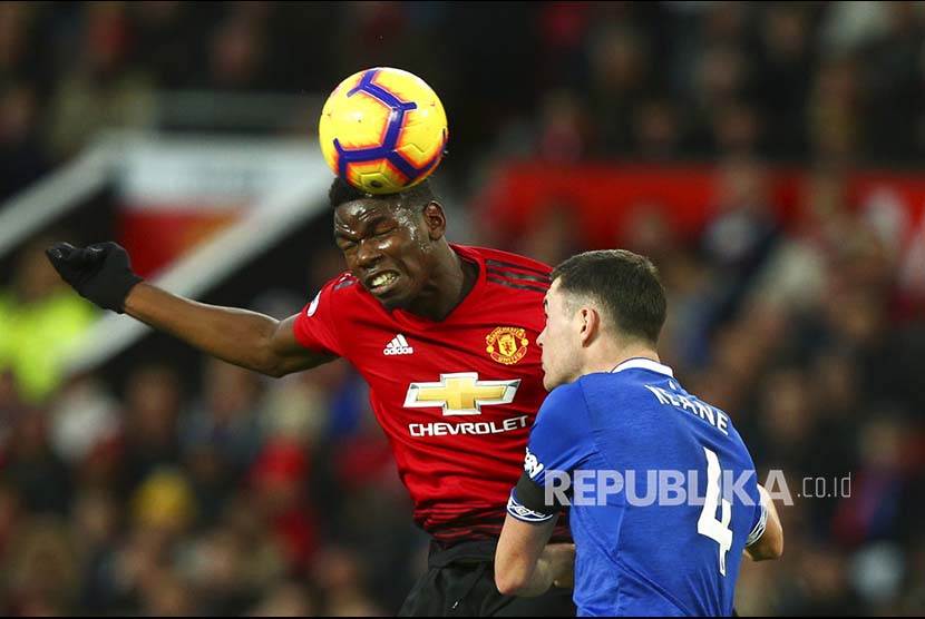 Paul Pogba dan Michael Keane berduel di udara pada pertandingan Liga Primer Inggris antara Manchester United melawan Everton di stadion, Old Trafford, Senin (29/10) dini hari.