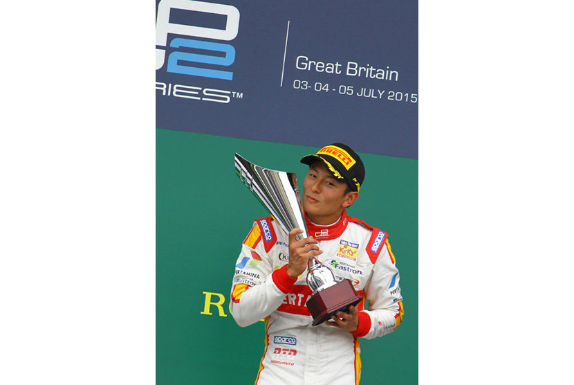 Pebalap Indonesia Rio Haryanto membawa piala usai memenangi balapan GP2 Series di Sirkuit Silverstone, Inggris, Minggu, (5/7).