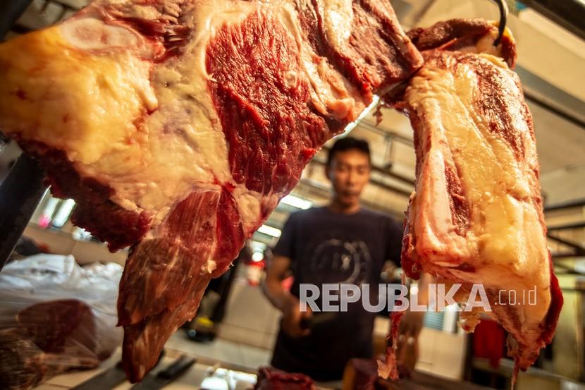 Pedagang daging memotong daging sapi di PD Pasar Jaya Kramat Jati, Jakarta, Ahad (27/2/2022). Kenaikan harga daging di Tanah Air diakibatkan lonjakan harga daging di pasar internasional.