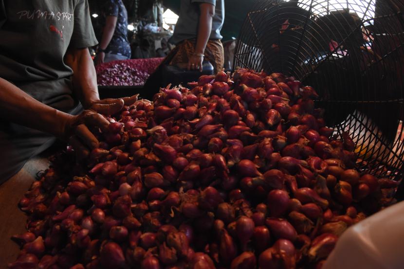 Pedagang memilah bawang merah yang dijual di pasar, (ilustrasi).