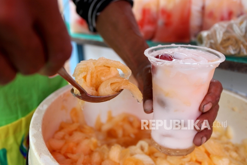  Pedagang mempersiapkan Es Blewah di standnya pada pasar takjil Bendungan Hilir, Jakarta, Senin (29/5).