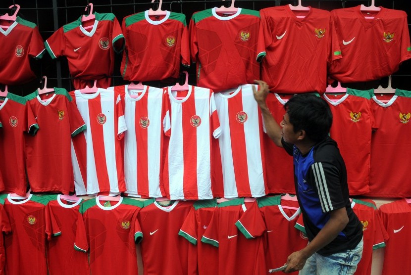 Pedagang menjual atribut timnas Indonesia jelang laga Indonesia melawan Vietnam di kawasan Cibinong, Kabupaten Bogor, Jawa Barat, Jumat (2/12). Atribut timnas sepeti kaos, syal, dan topi dijual dengan harga Rp50 ribu hingga Rp75 ribu.