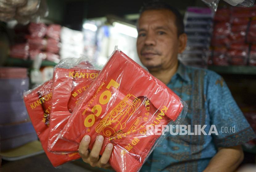 Pedagang menunjukkan kantong plastik di Pasar Senen, Jakarta. Menteri Keuangan Sri Mulyani mengusulkan pemungutan cukai terhadap kantong plastik sebesar Rp 200 per lembar atau Rp 30.000 per kilogram mulai tahun ini. 