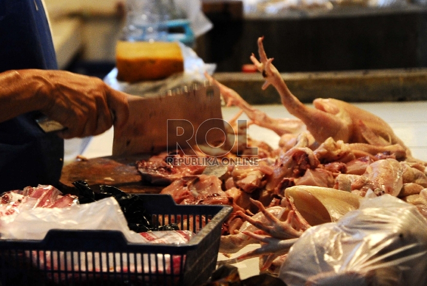 Pedagang sedang memotong ayam dilapak tempat berjualan di pasar tradisional, Jakarta, Selasa (4/8).