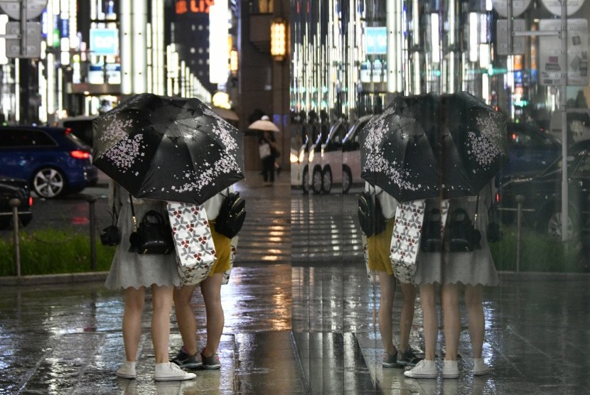 Pedestrian membawa payung di Ginza, Tokyo, Jepang, 4 Juli 2017. Jepang dilanda badai Nanmadol yang menyebabkan hujan deras pada malam hari. 