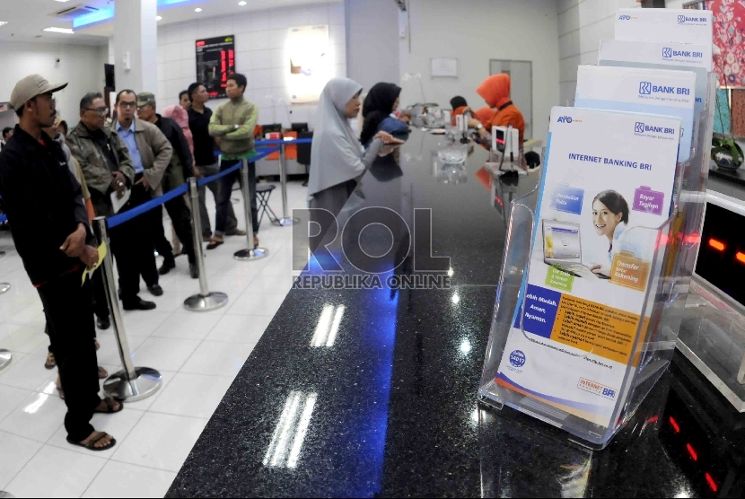 Pegawai melayani nasabah di banking hall Bank BRI, Jakarta, Selasa (15/9). 