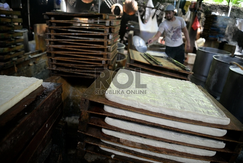 Pekerja melakukan proses pembuatan tahu di salah satu pabrik di Mampang, Jakarta, Rabu (11/3).