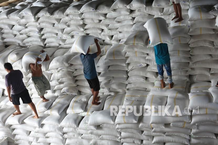 The workers shouldered sacks of rice in a Bulog's warehouse. The Indonesian government finally cancelled rice imports until June 2021.