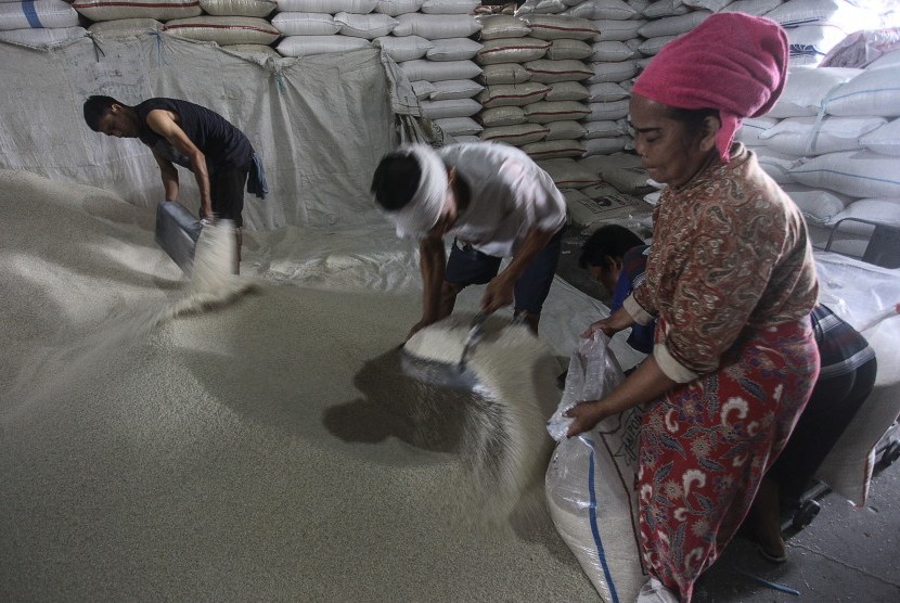Pekerja memasukan beras kedalam karung di Pasar Induk Beras Cipinang (PIBC), Jakarta, Kamis (3/3).