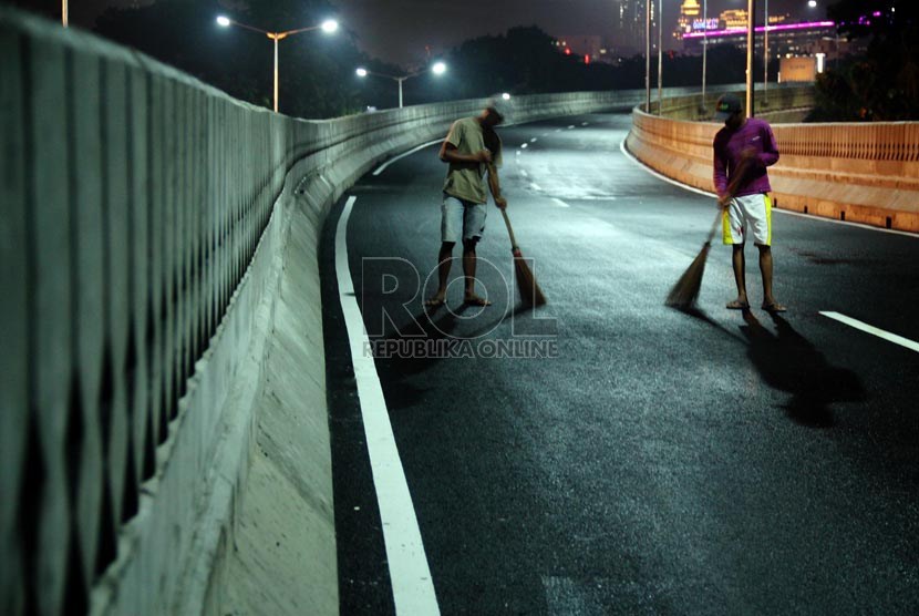  Pekerja membersihkan jalan layang non tol Antasari - Blok M, Jakarta, Ahad (13/1). (Republika/Yasin Habibi)