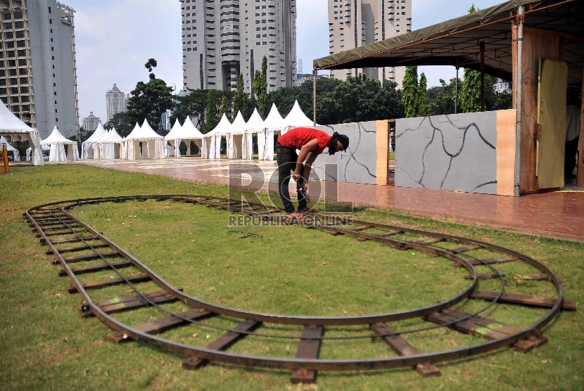 Pekerja mempersiapkan sejumlah wahana arena bermain anak untuk meramaikan Pesta Rakyat Jakarta di Parkir Timur, Senayan, Jakarta Pusat, Rabu (27/5).