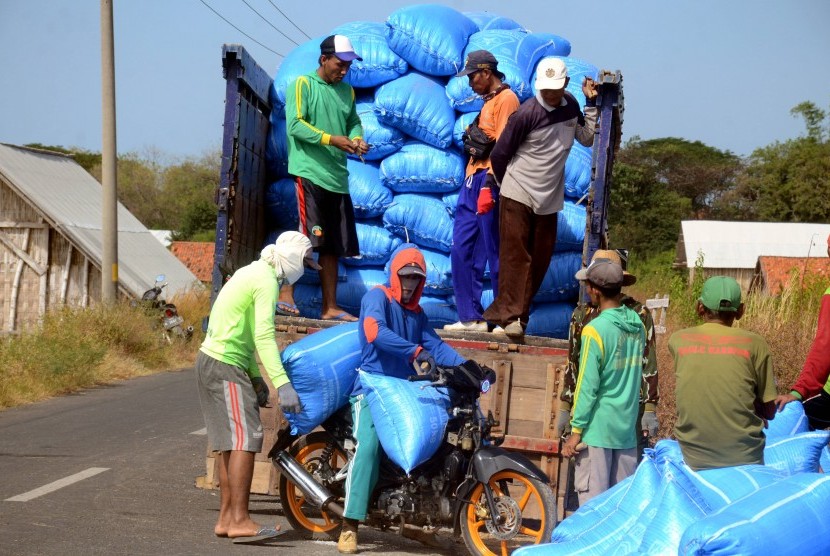 Pekerja menaikkan garam rakyat ke atas truk di Desa Bunder, Pamekasan, Jawa Timur, Kamis (20/6/2019).