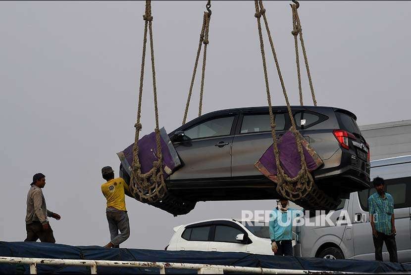 Pekerja menaikkan mobil ke atas kapal di Pelabuhan Sunda Kelapa, Jakarta, Jumat (14/9). Pemerintah menyatakan pembatasan impor otomotif dapat menggenjot produksi industri otomotif dalam negeri untuk kebutuhan domestik dan impor. 