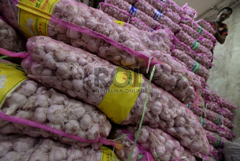 Pekerja menata tumpukan bawang putih impor di Pasar Induk Kramat Jati ,Jakarta, Kamis (5/3).