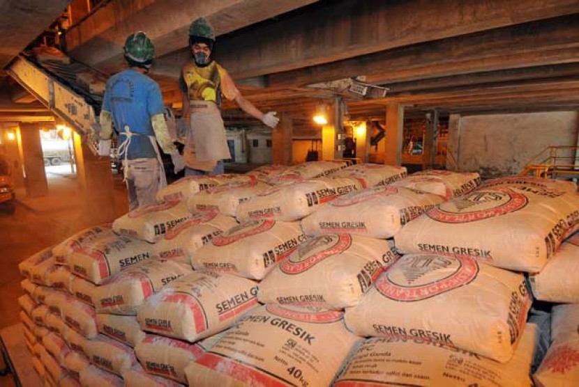 Pekerja mengemas semen ke dalam karung di pabrik semen milik PT Semen Indonesia (Persero) Tbk.