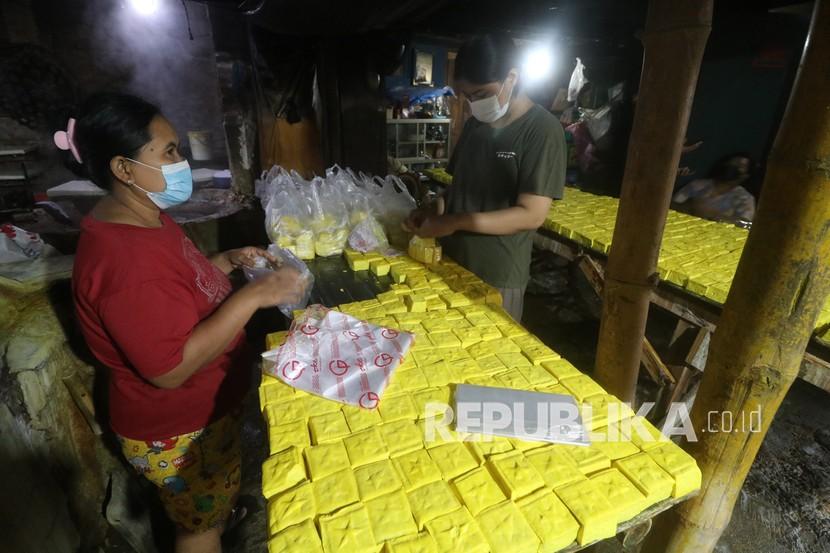 Pekerja mengemas tahu takwa khas Kediri ke dalam kantong plastik di Kampung Tahu Kelurahan Tinalan, Kota Kediri, Jawa Timur.