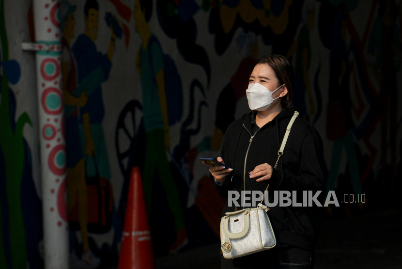 Pekerja mengenakan masker saat beraktivitas di kawasan Sudirman, Jakarta, Senin (14/8/2023). 