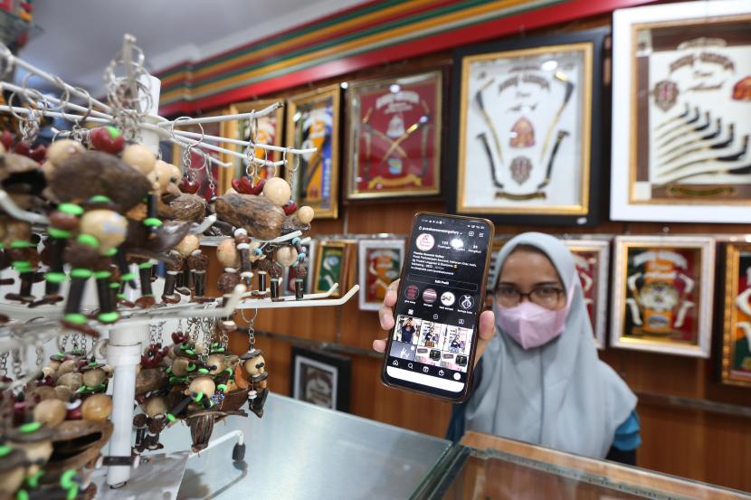 Pekerja menunjukkan berbagai produk UMKM yang dipasarkan secara daring atau digital di Pusaka Sauvenir, Peunayong, Banda Aceh, Aceh, Minggu (25/7/2021). Menteri Koperasi dan UKM Teten Masduki menyebutkan hingga bulan Juni 2021 sebanyak 6,5 juta pelaku usaha dan pemasaran produk UMKM telah beralih ke ekosistem digital sebagai upaya adaptasi dengan kondisi pandemi COVID-19.