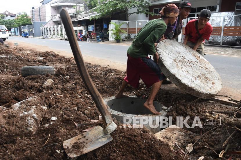 Pekerja menyelesaikan pembuatan sumur resapan di kawasan Tebet, Jakarta Selatan, Rabu (24/11/2021). 