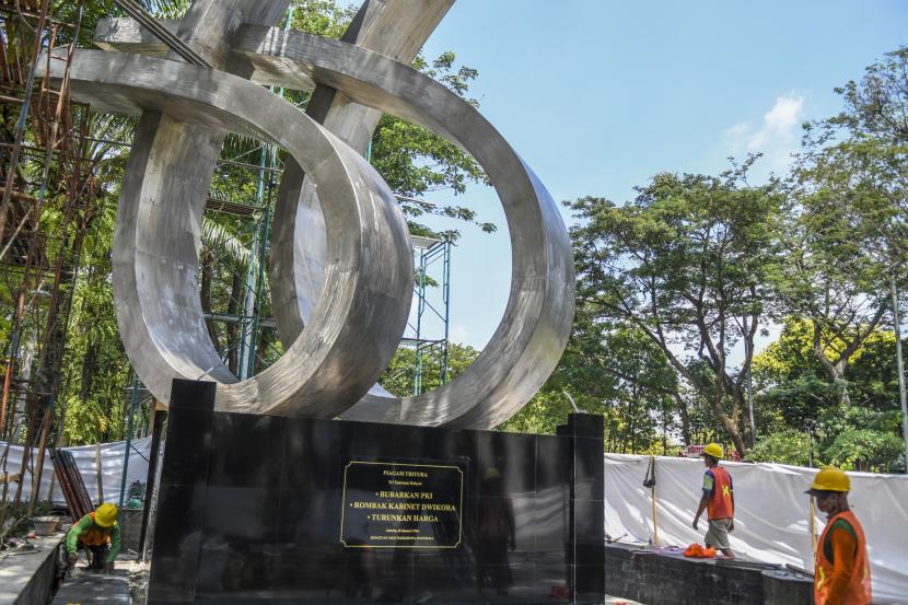 Pekerja menyelesaikan pemindahan monumen Tritura atau tugu 66 di Taman Menteng, Jakarta, Senin (8/8/2022). Pemprov DKI Jakarta memindahkan tugu 66 dari kawasan jalan Rasuna Said, Kuningan ke Taman Menteng karena tertutup halte busway dan terhalang stasiun LRT. 