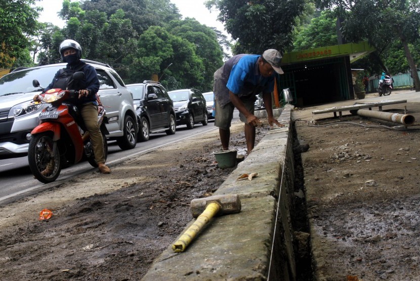 Pekerja saat menyelesaikan pembangunan pedestrian di Jalan Pajajaran, Kota Bogor, Jawa Barat, Rabu (23/3).